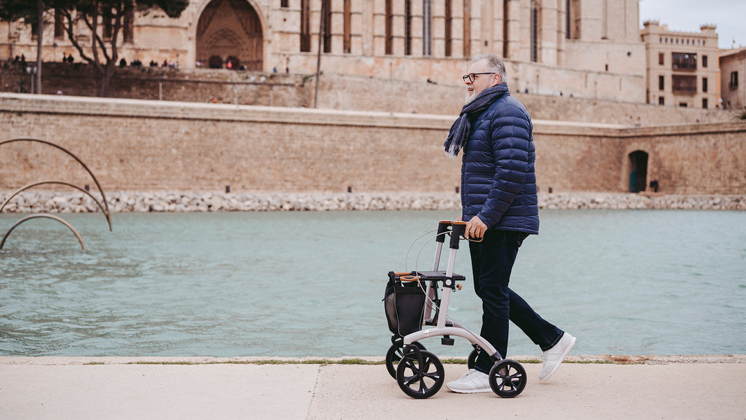 A man walks along a river in Europe with a Saljol Aluminium Walker