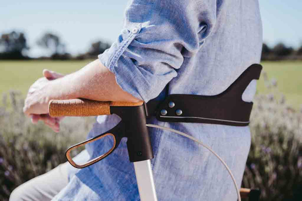 A man sits and leans on a Saljol backrest on a walker rollator
