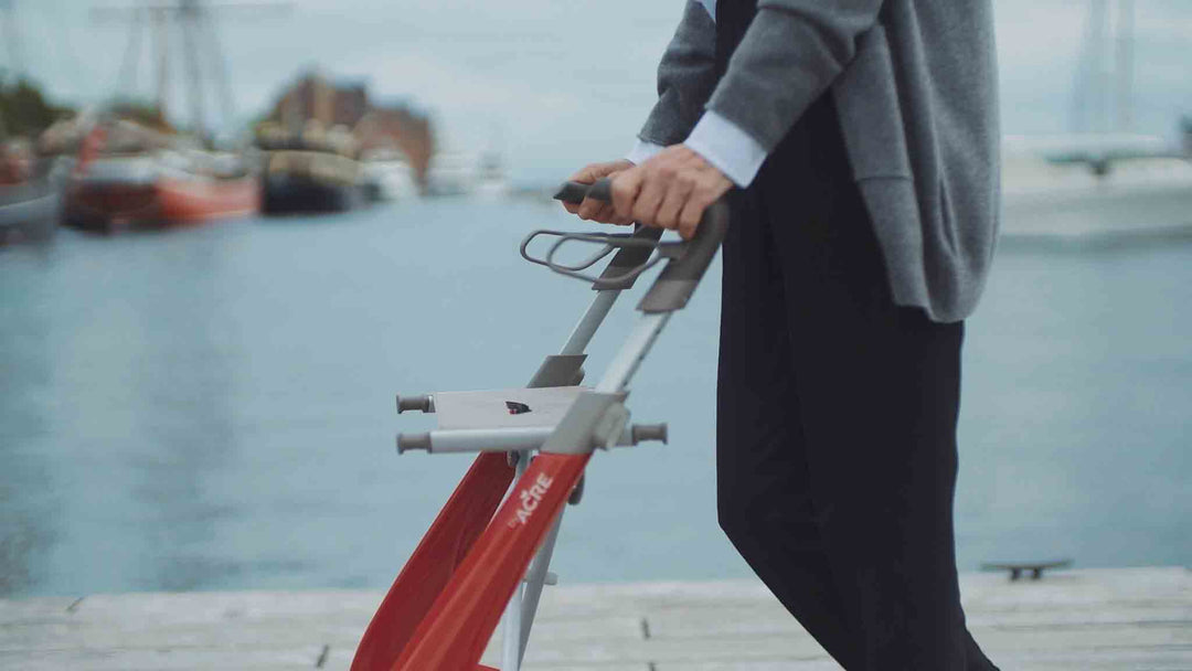 Close up of the handles of a 'byACRE Ultralight' walking frame