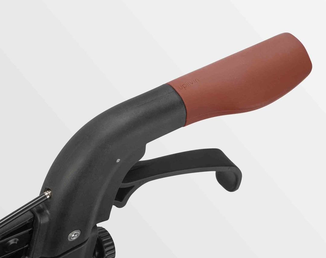 A close up of the handle of an 'Uplivin Trive' walker rollator.