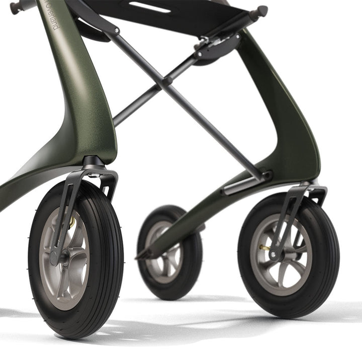 Close up of the front tyres on a green 'byACRE Carbon Overland' rollator, on a white background.