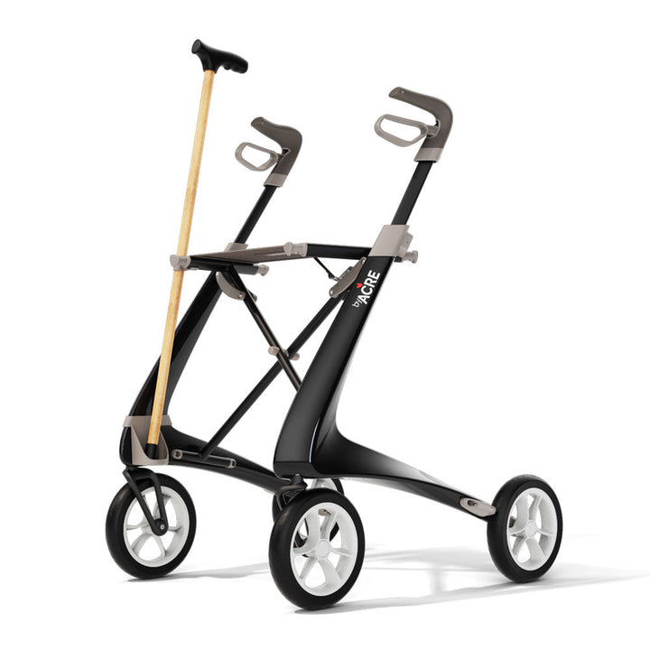 A byACRE Carbon Ultralight rollator with a walking cane attached on a white background