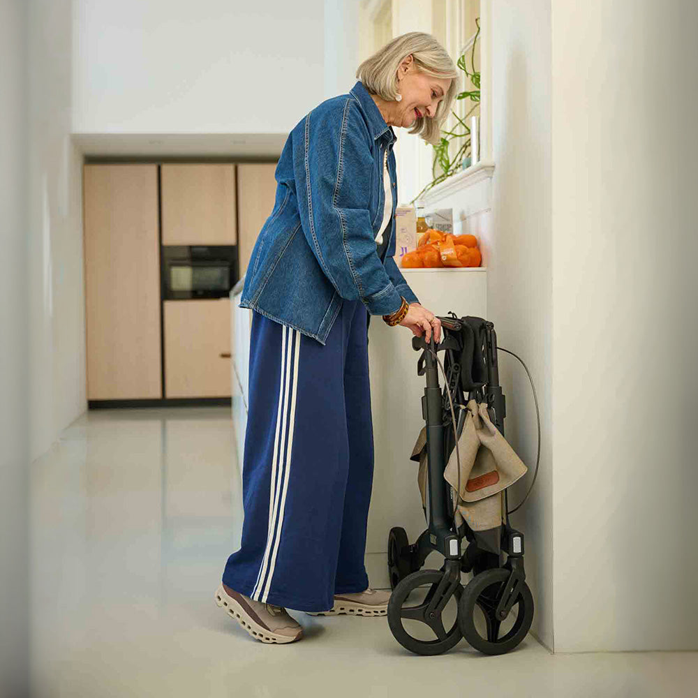 Woman in a kitchen using a mobility scooter.