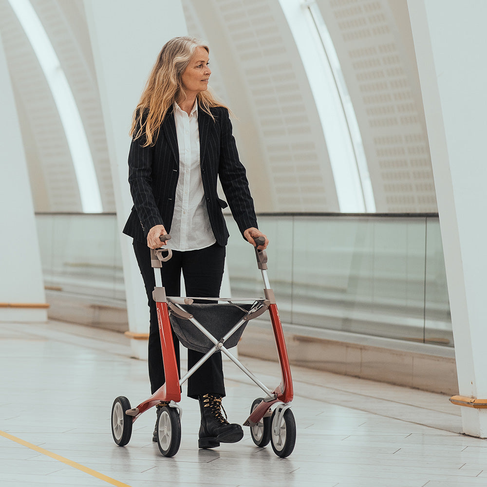a woman walks supported by a byacre carbon ultralight walker