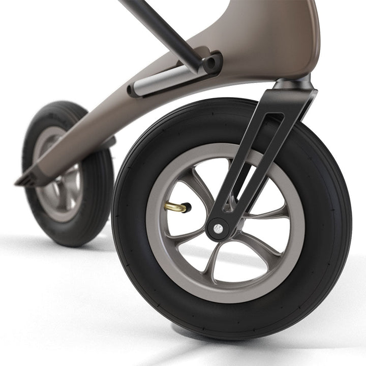 Close up of a front wheel on a brown 'byACRE Carbon Overland' rollator, on a white background.